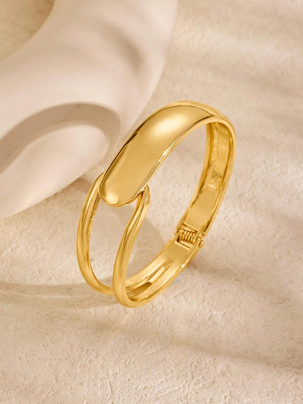 Elegant Gold-Tone Cuff Bracelet with Intricate Design Details