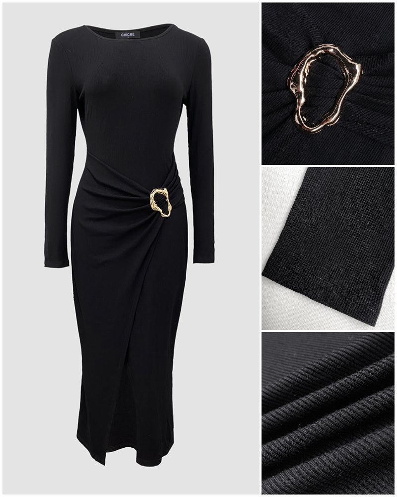 Black ribbed knit wrap dress with long sleeves, cinched waist, and gold abstract buckle.
