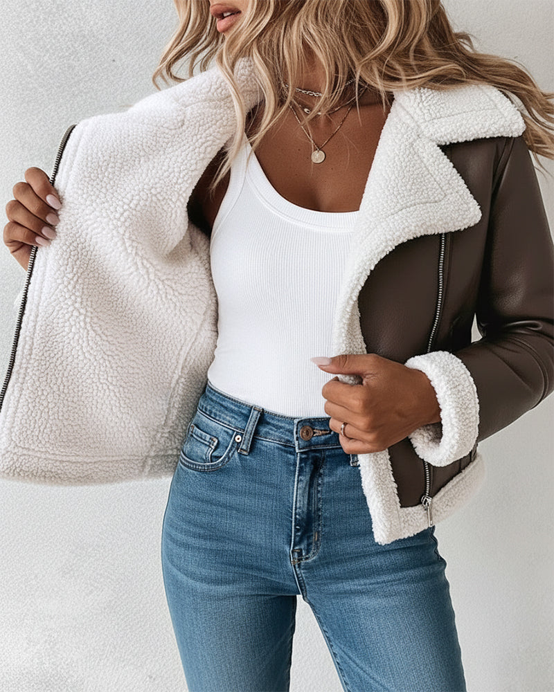 Faux leather shearling-trimmed biker jacket styled over a white tank and blue jeans.