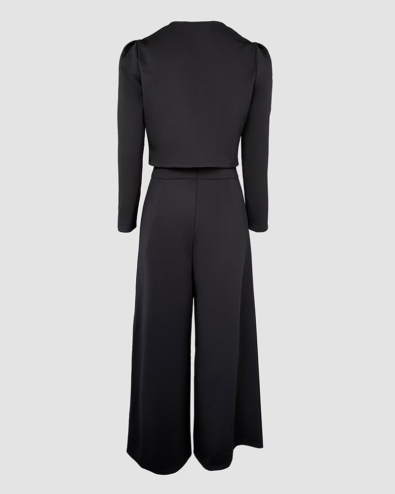 Black 2-piece set with square neck jumpsuit, crop cardigan, fitted waist, and wide-leg pants.