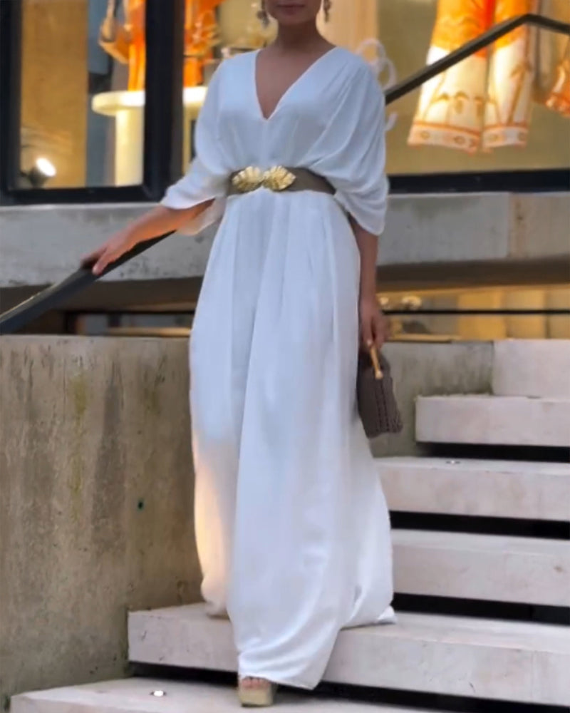 Deep V-neck jumpsuit with ruched sleeves and waist ties in a flattering silhouette.
