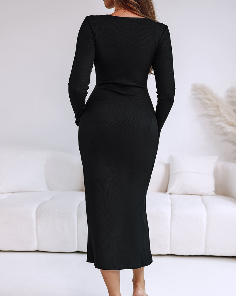A ribbed wrap dress with a cinched waist and mid-length ring detail in neutral tones.