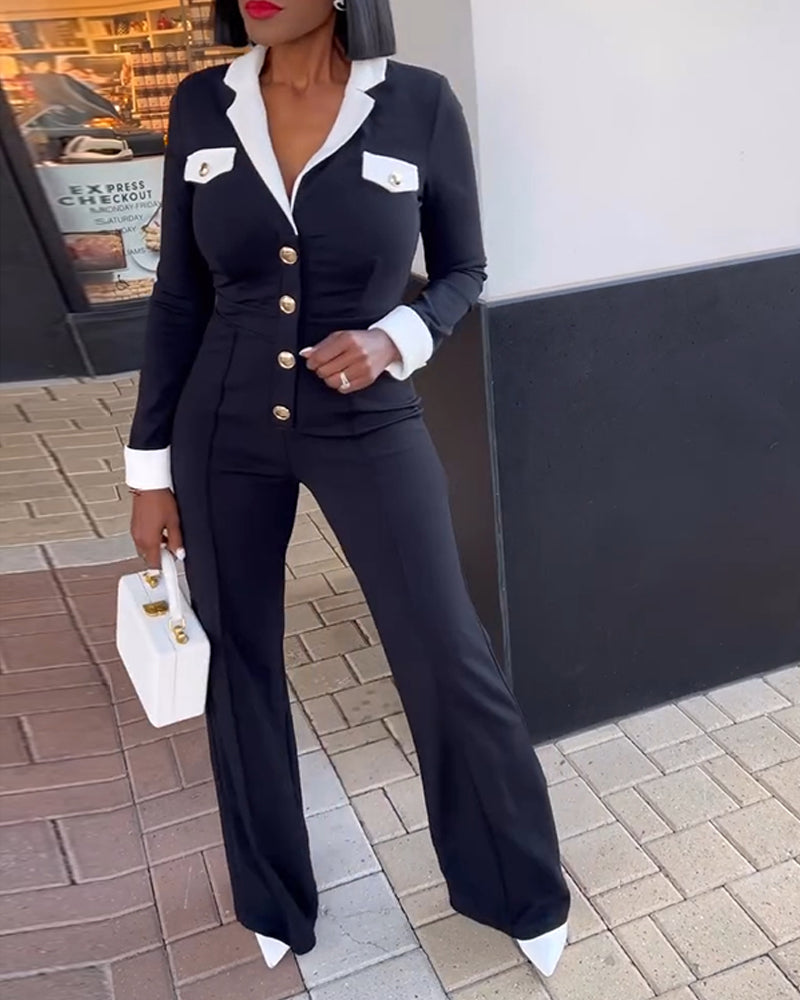 Colorblock wide leg jumpsuit with metal button accents, white cuffs, collar, and pocket flaps.
