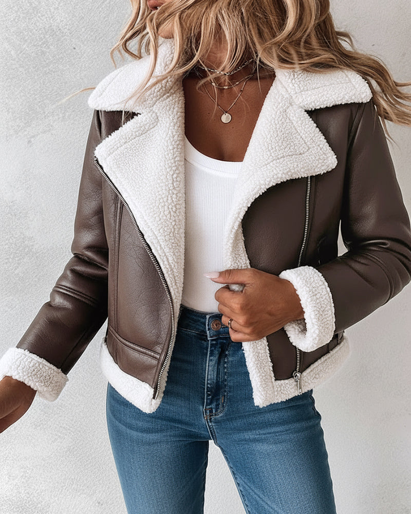  faux leather shearling-trimmed thermal biker jacket, white ribbed top, blue jeans.