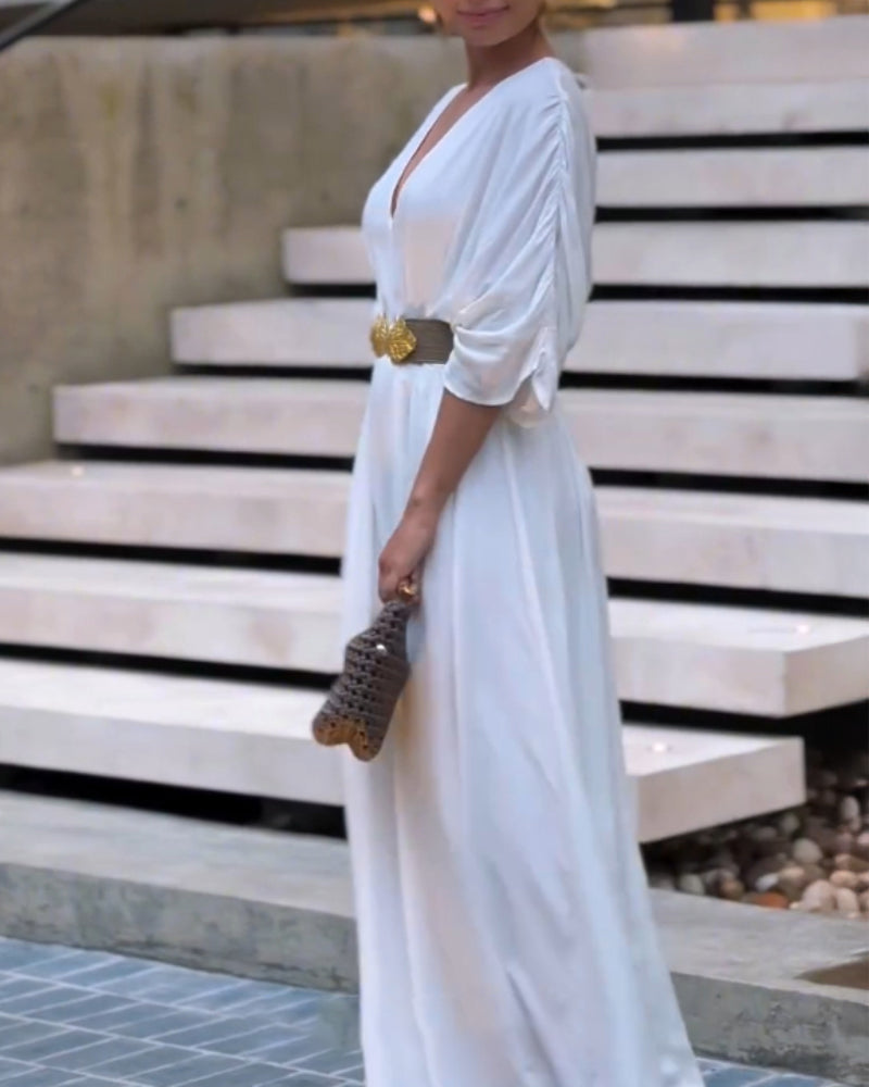 Deep V-neck jumpsuit with ruched sleeves and waist ties in a contemporary style.