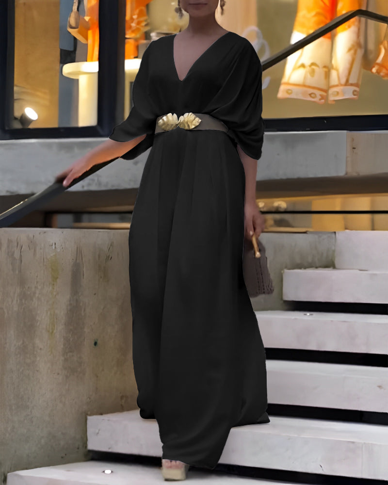 A flowing black Deep V-Neck Jumpsuit with ruched sleeves and waist ties.