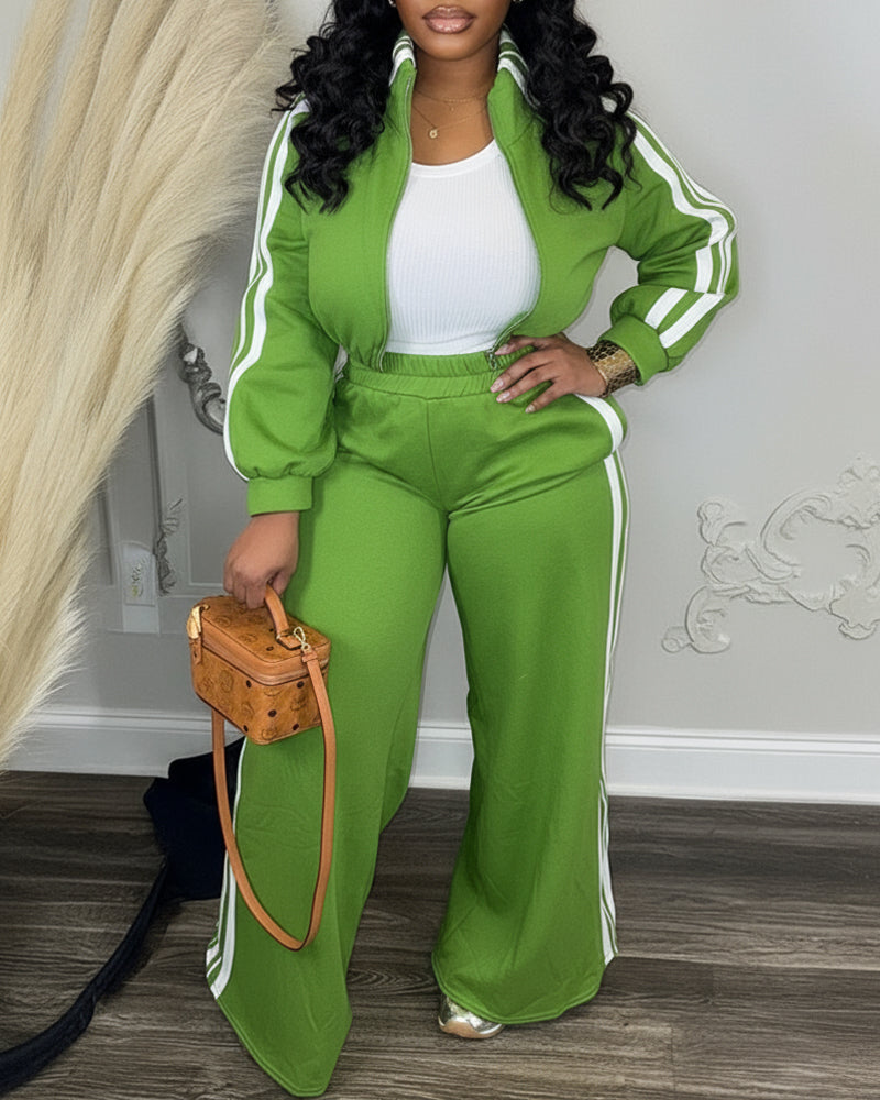 Bright green zip crop jacket and wide-leg pants with white side stripes, plus white crop top.