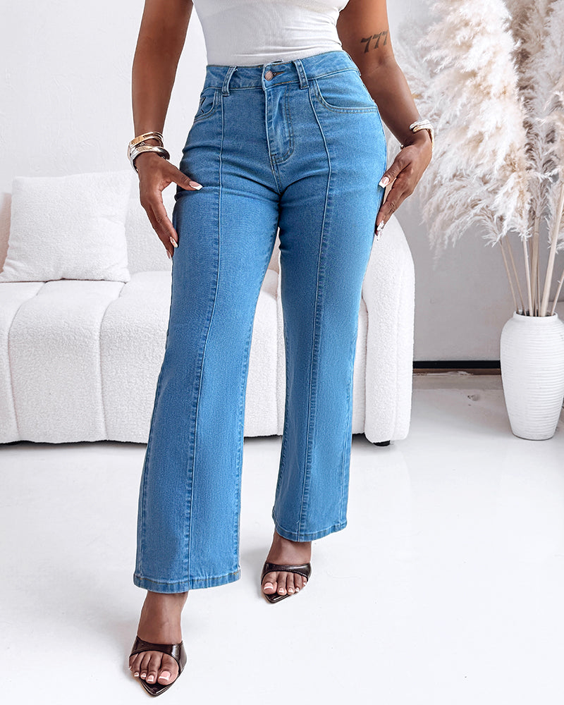 high waist straight leg seam front zip jeans with a white sleeveless top.
