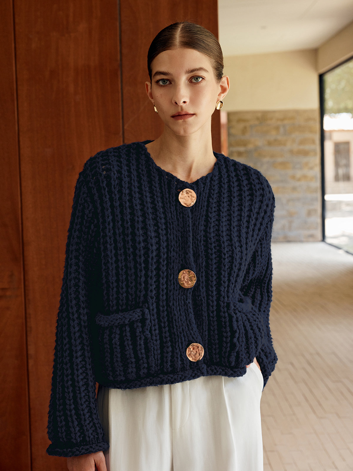 Timeless Button-Up Cardigan in soft knit with three gold buttons, styled with white pants.