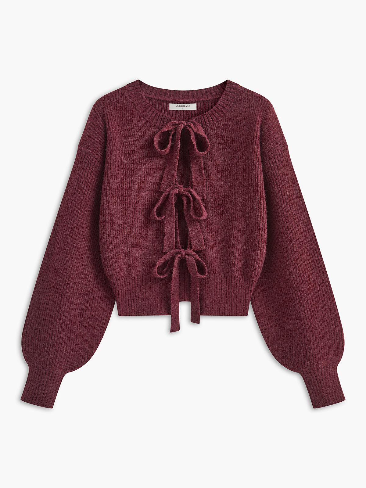 A maroon cropped knit cardigan with lace trim, ribbed texture, three bows, and balloon sleeves.