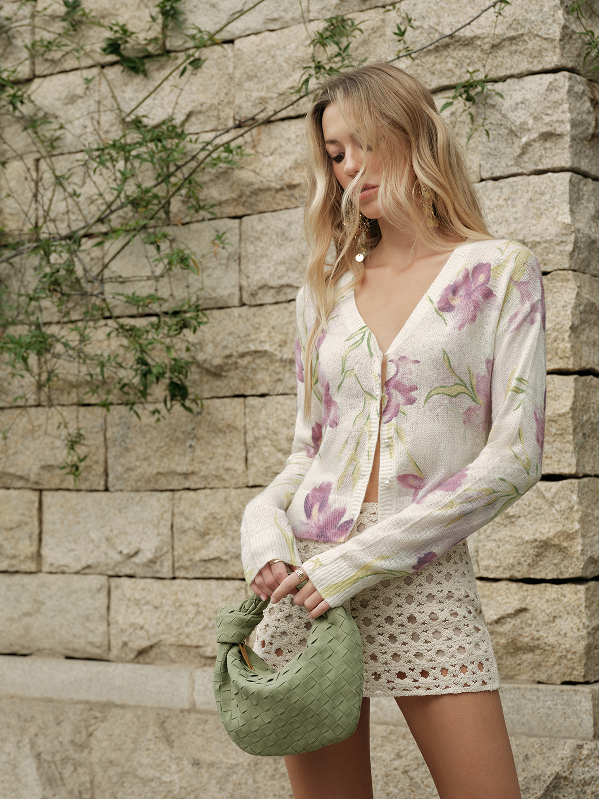 Floral wool-blend knit cardigan with cozy patterns paired with cream crochet shorts.