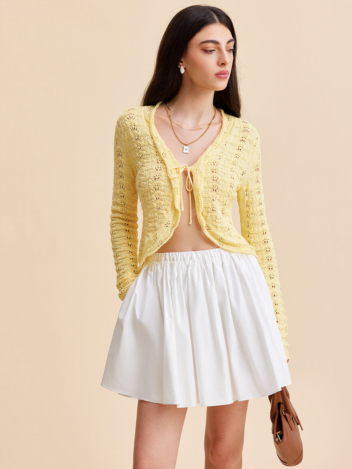 KOAD'CLO crocheted cardigan sweater with a tie-front design in a textured knit.