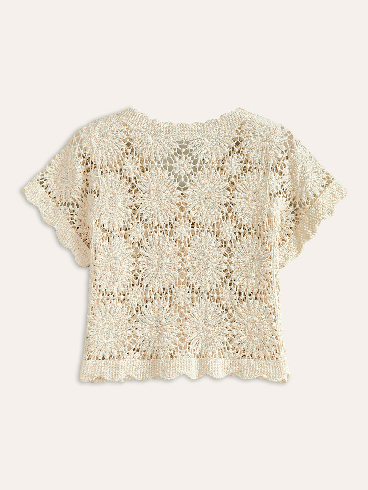 Cream crochet cardigan with floral pattern, button-up front, short sleeves, and scalloped edges.