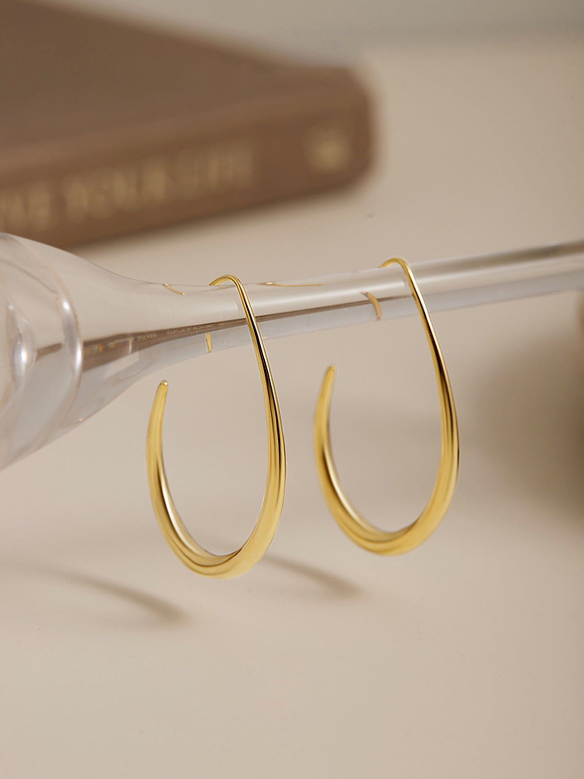 Golden Fluid Hoop Earrings with Elegant Drop Design