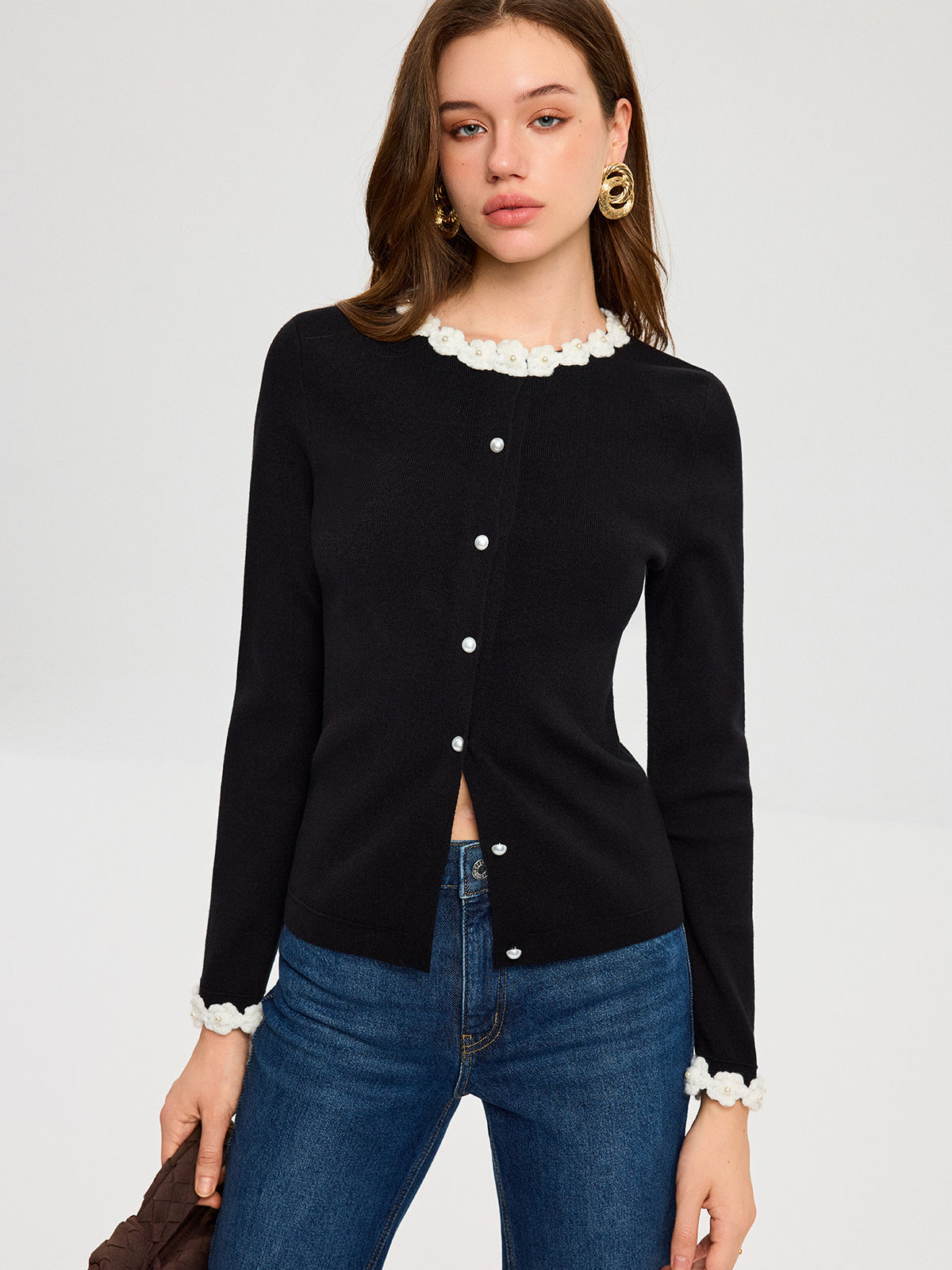 KOAD'CLO 3D Floral Embroidered Cardigan with pearl buttons, floral trim, and blue jeans.