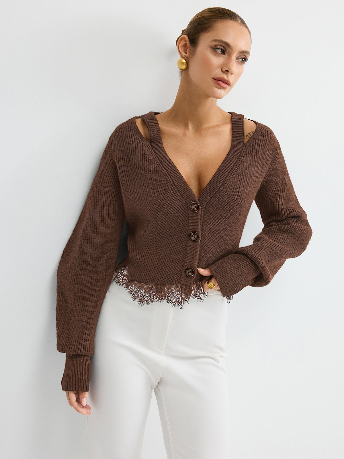 KOAD'CLO Wool Blend Cardigan with lace hem detail over a strappy top and white high-waisted pants.