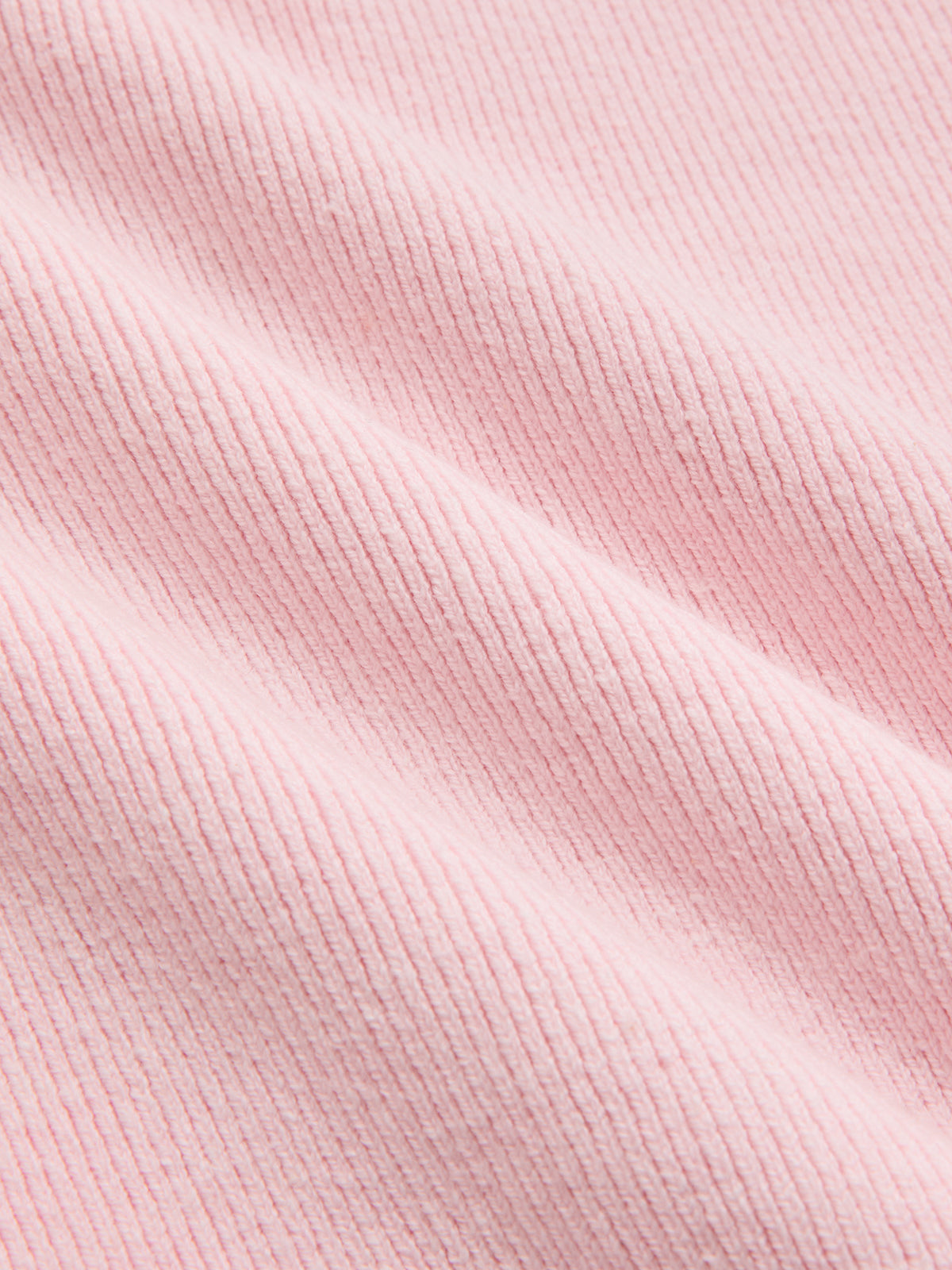 Light pink ribbed corduroy-like short sleeve cardigan with delicate folds and lace trim detailing.