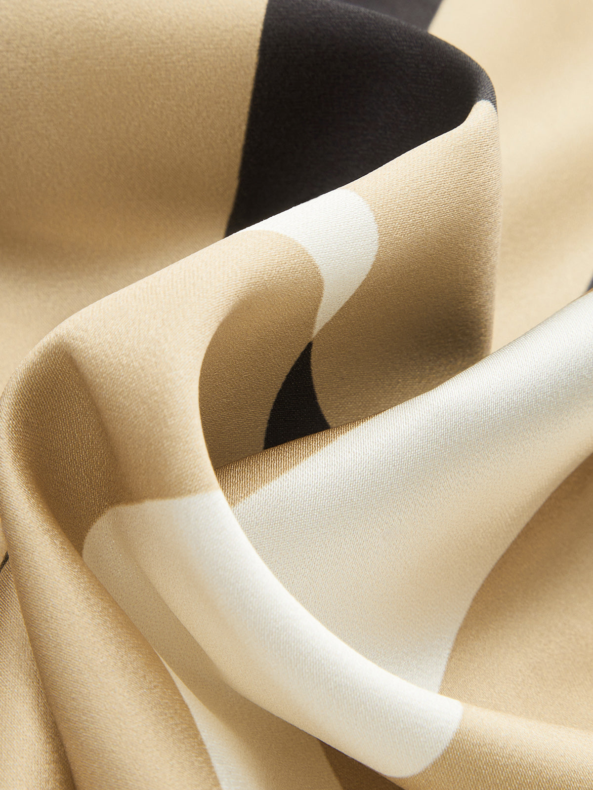 Geometric-stripe satin halter top with asymmetric hem, scarf-style cut, and adjustable neck tie.