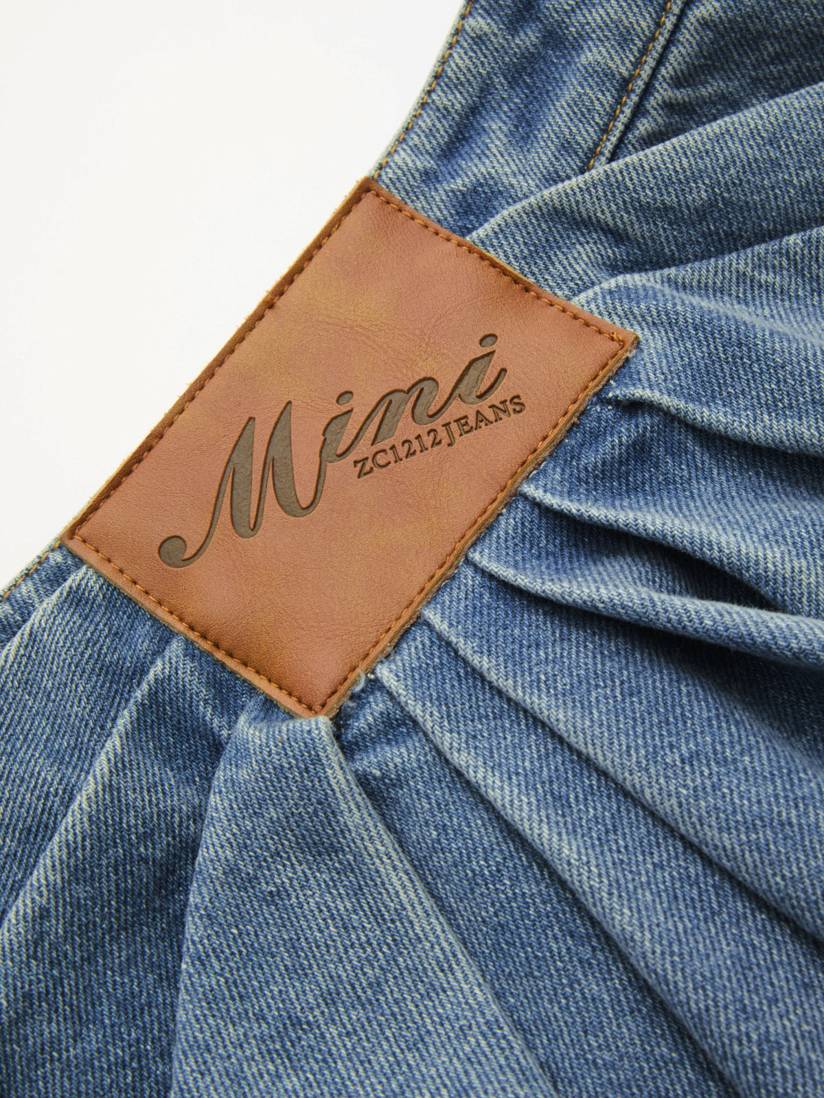 Asymmetric Pleated Denim Mini Skirt with High Waist Design