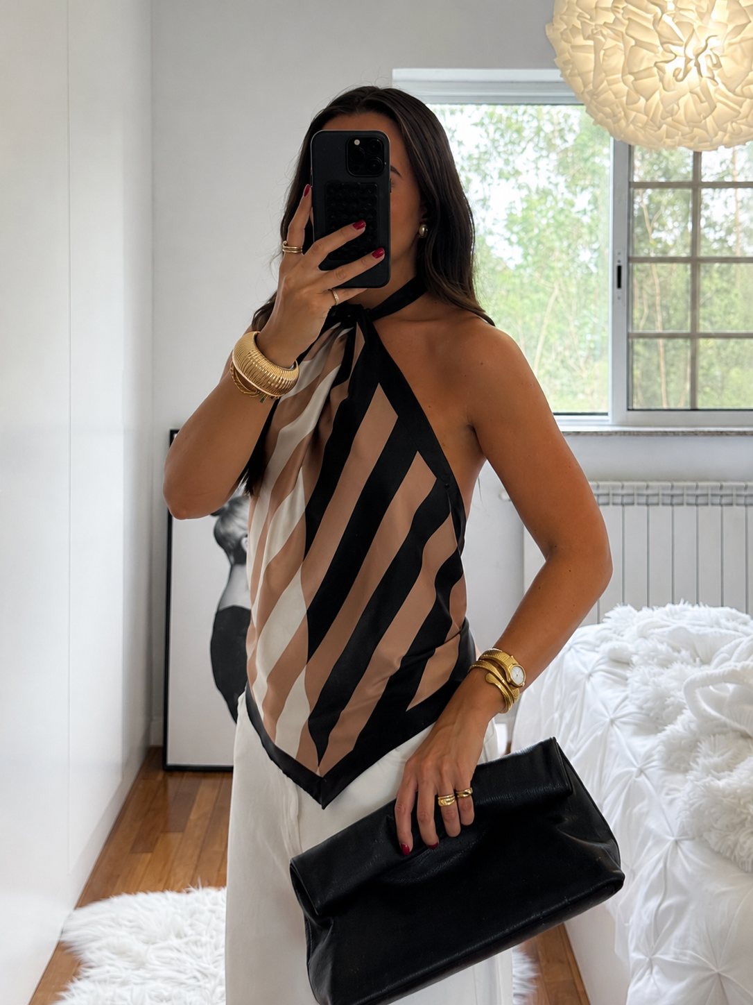 Geometric-stripe satin halter top with asymmetric hem, scarf-style cut, and adjustable neck tie.